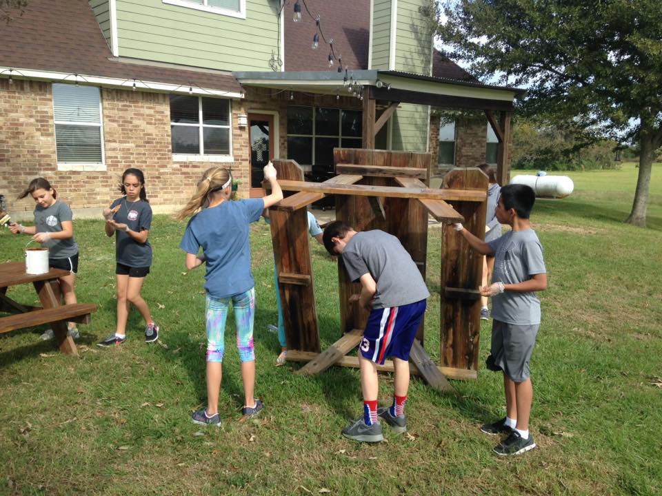 Youth building picnic tables